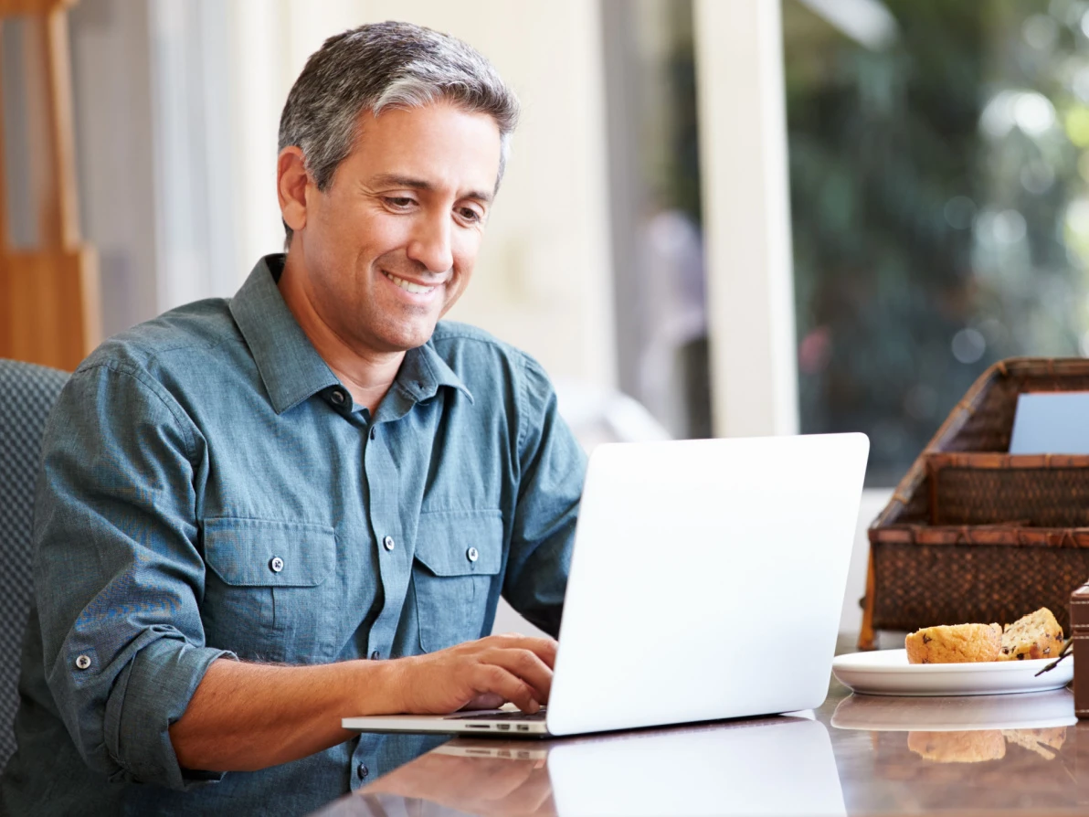 man using laptop to find out how he can finance lasik eye surgery