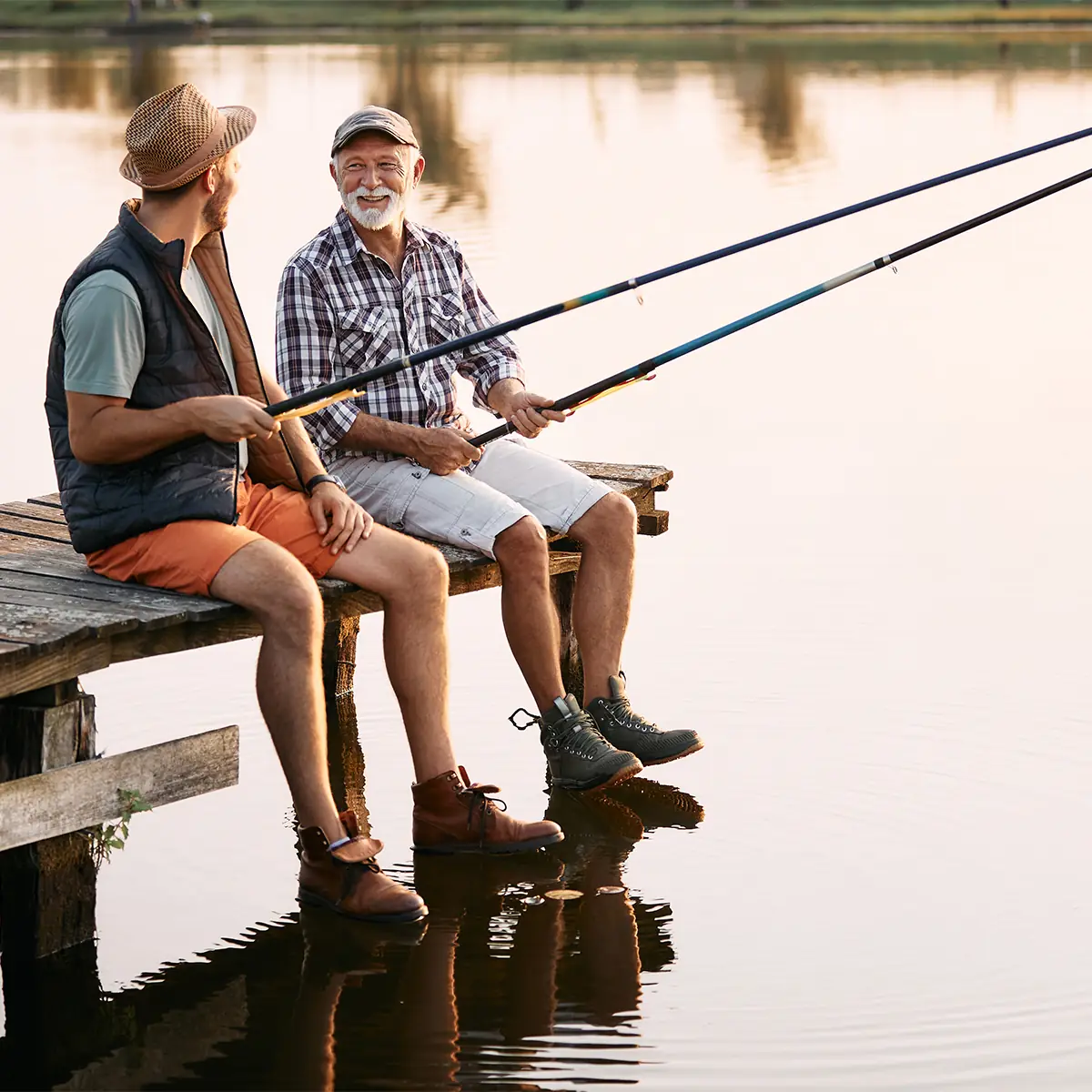 senior man fishing with son
