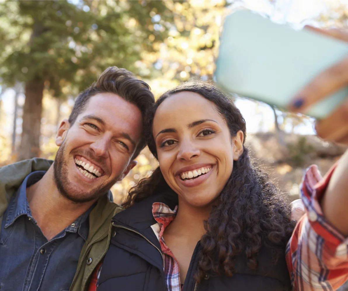 Young happy couple taking a picture together outdoors