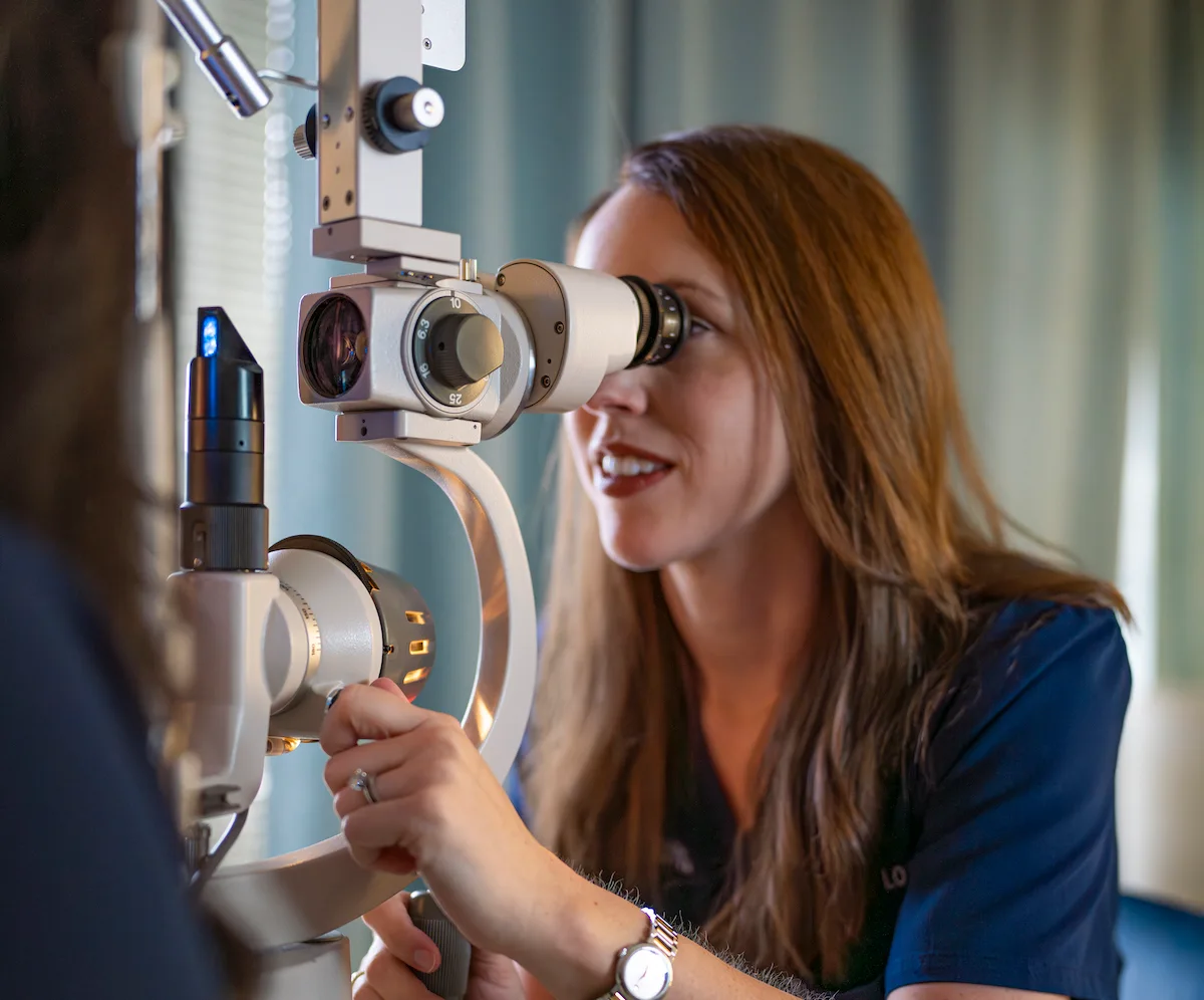 Dr. Lozano using slit lamp on patient