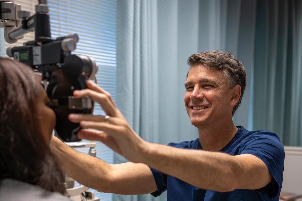 Dr. Welton using phoropter on patient